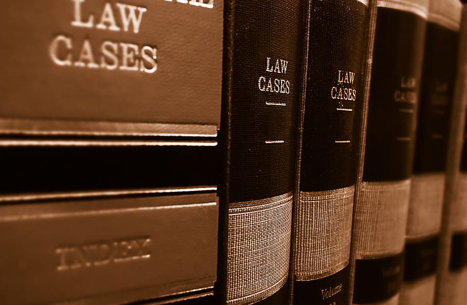 A row of textbooks on a shelf titled Law Cases.